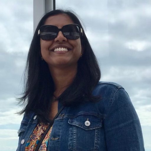 photo of Zalina Alvi, a woman with long black hair wearing a denim jacket and sunglasses.